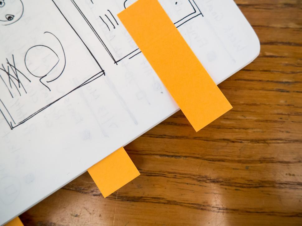 Free Image of Notebook with sketch and orange bookmark 