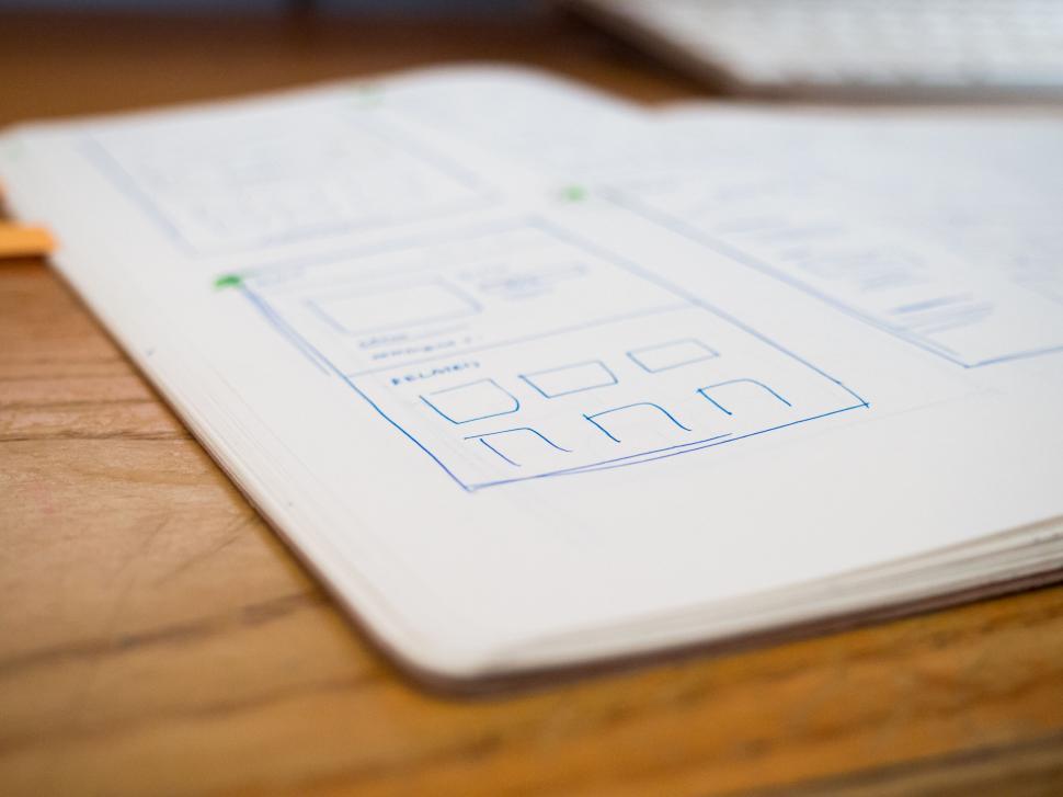 Free Image of Designer s notebook with website layout sketches 