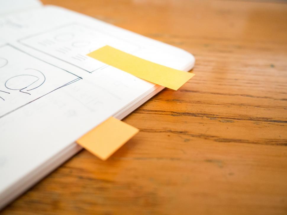Free Image of Open notebook with sticky notes on table 