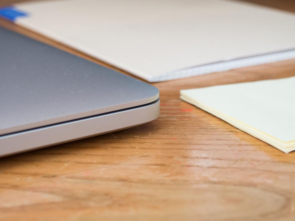 Free Image of Close-up of laptop edge and notepad 