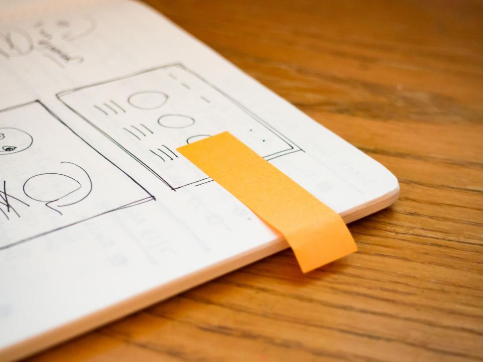Free Image of Notebook with UXUI design sketches and marker 