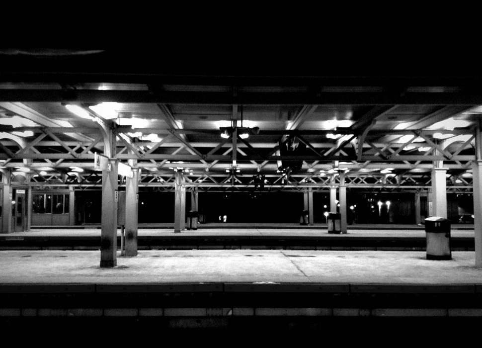 Free Image of Desolate train station platform in black and white 