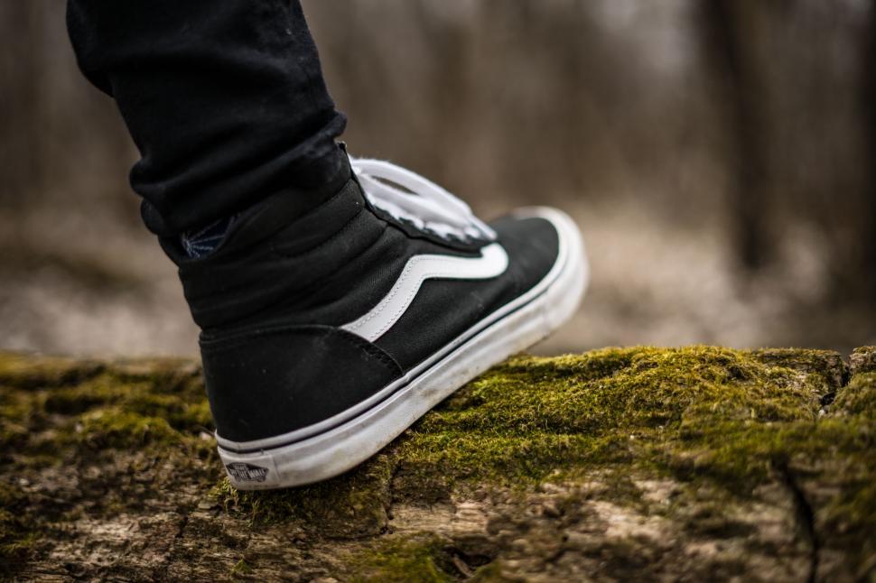 Free Image of Person wearing black and white sneakers 
