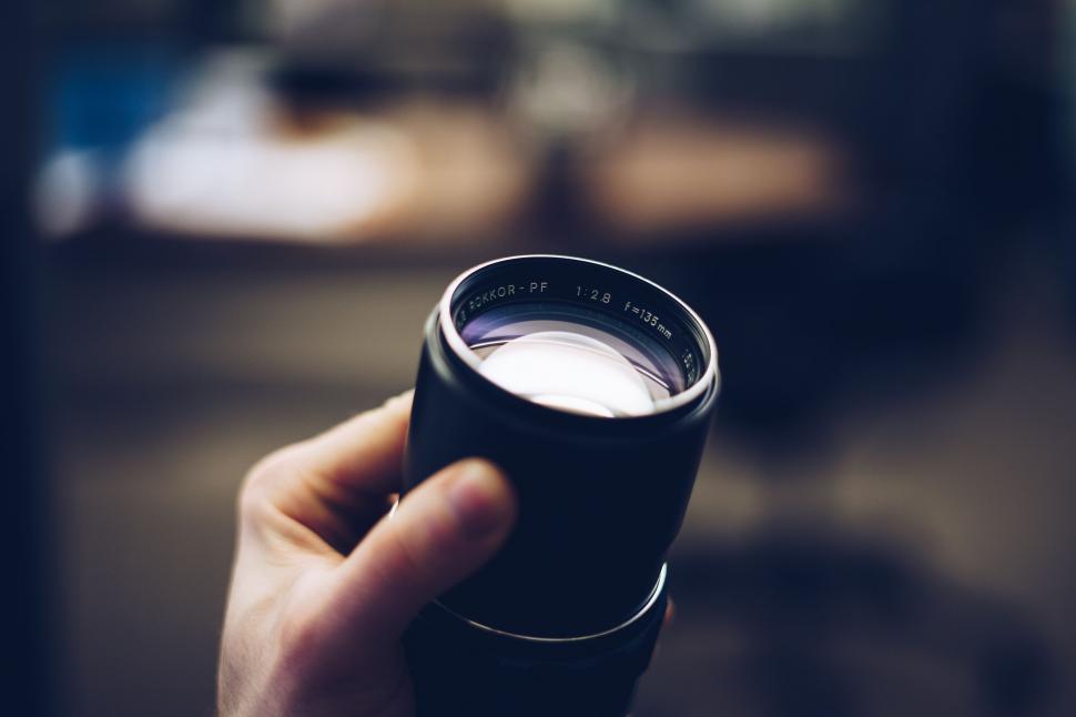 Free Image of Close-up of a camera lens held in hand 