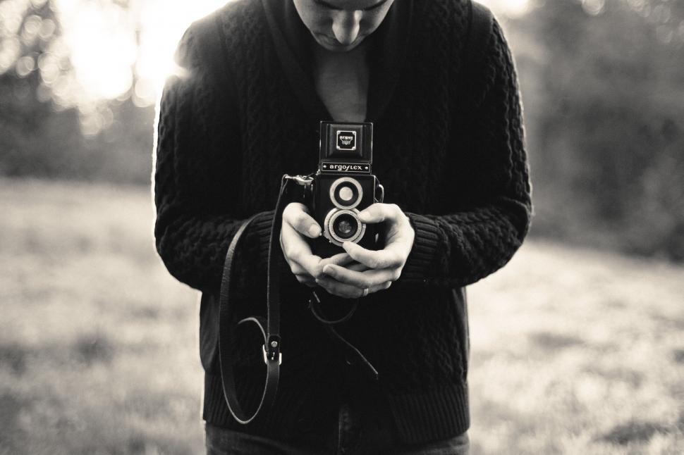 Free Image of Person holding vintage camera 