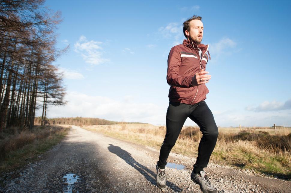 Free Image of Man jogging on countryside road 