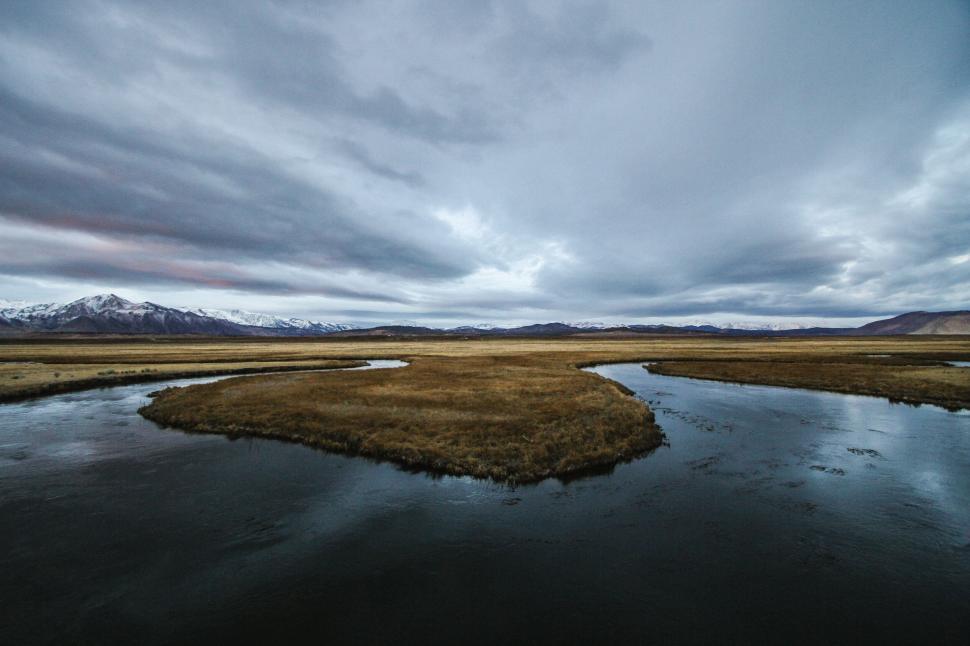 Free Image of Vast wetland under a cloudy sky 
