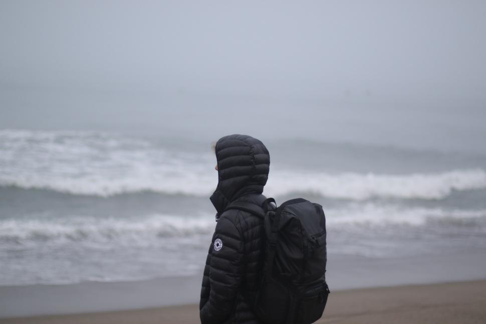 Free Image of Person with backpack looking at the sea 