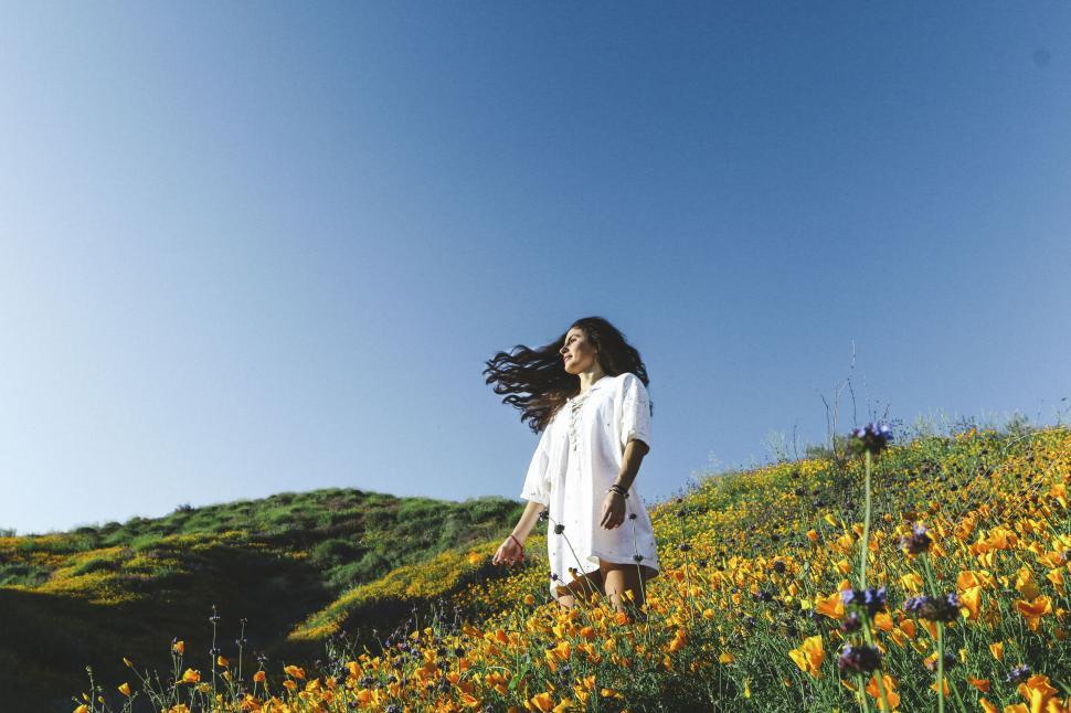 Free Image of Woman enjoying nature in a flower field 