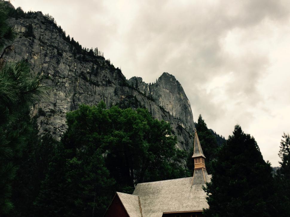 Free Image of Chapel at the base of towering cliffs 