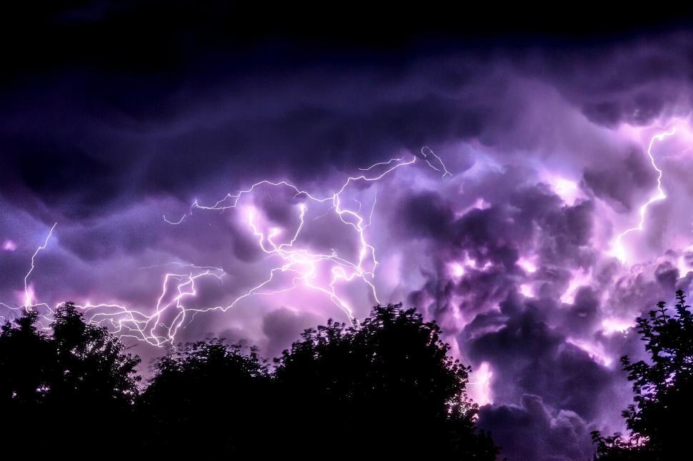 Free Image of Dramatic thunderstorm with intense purple lightning 