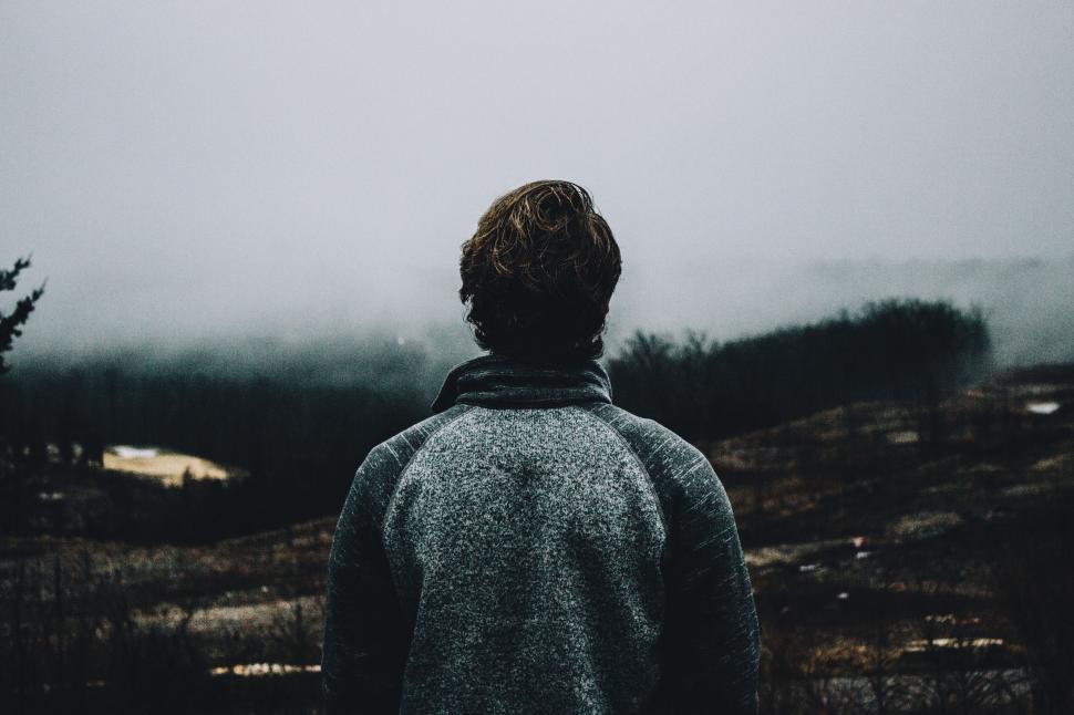 Free Image of Man looking at foggy landscape in winter 