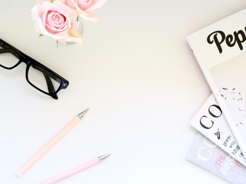 Free Image of Workspace with glasses and feminine accessories 