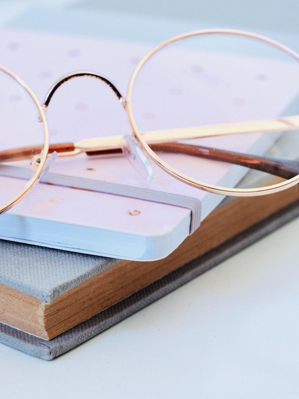 Free Image of Glasses on a book with soft background 