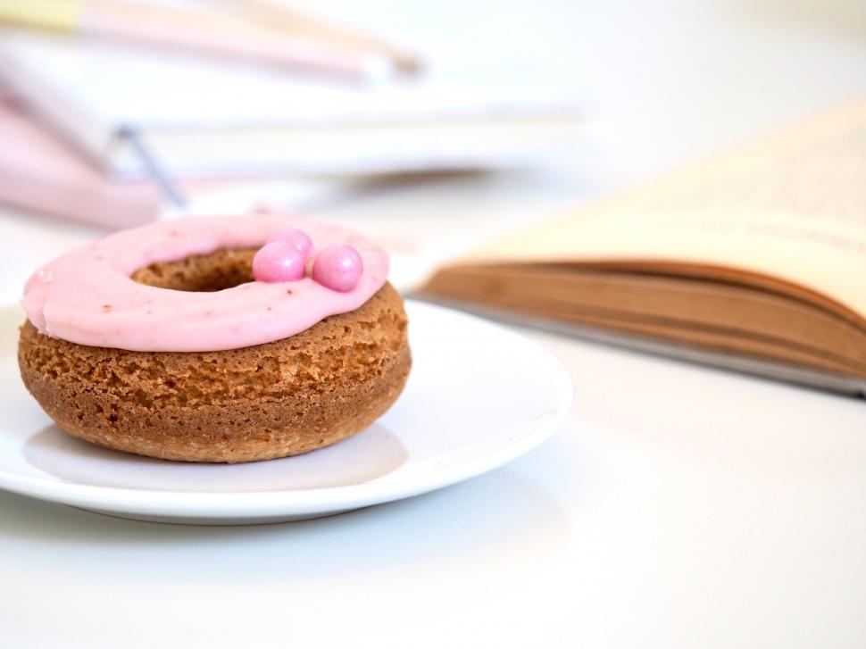 Free Image of Pink frosted donut on a white plate 