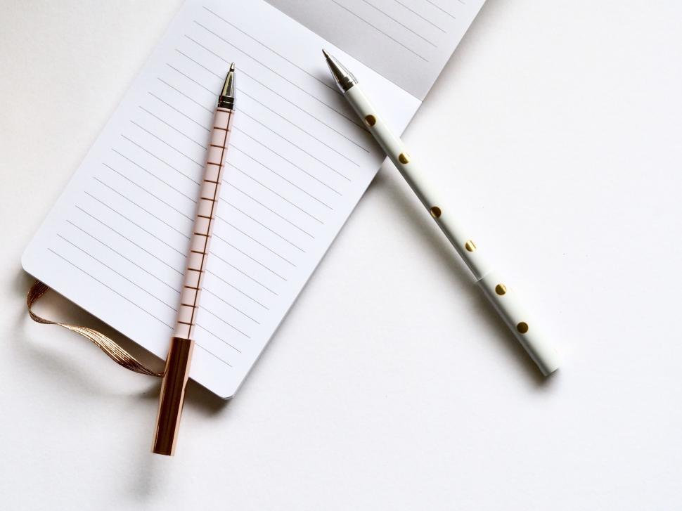 Free Image of Open notebook with pen on white background 