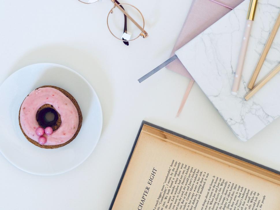 Free Image of Donut on plate with book and stationery 