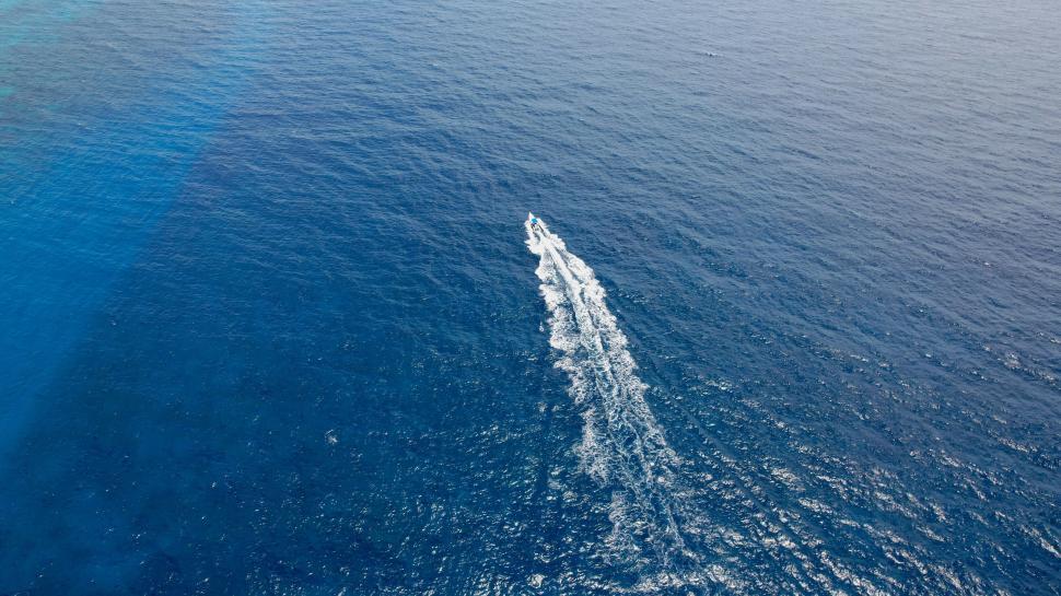 Free Image of Speedboat leaving trail on deep blue sea 
