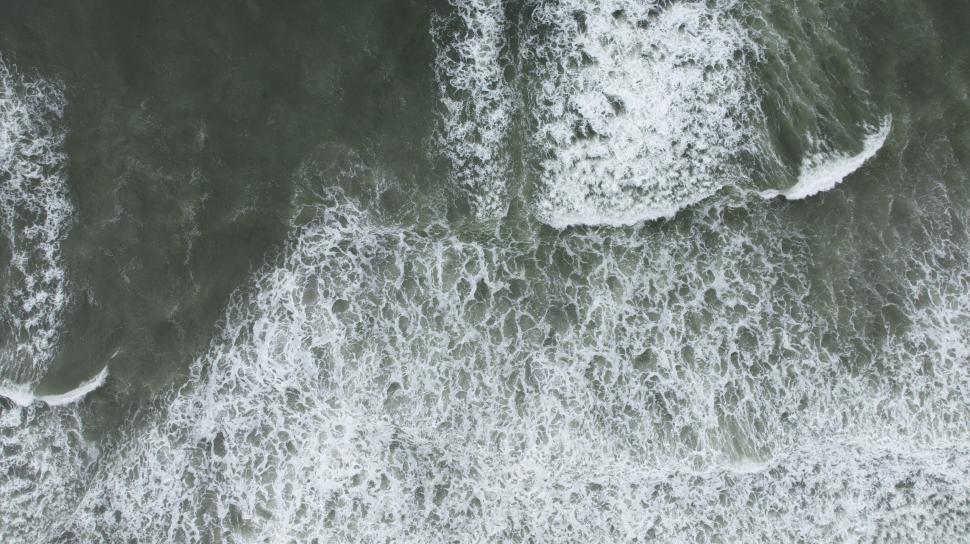 Free Image of Overhead shot of ocean waves frothing 