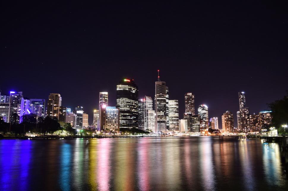 Free Image of City skyline reflected in water at night 