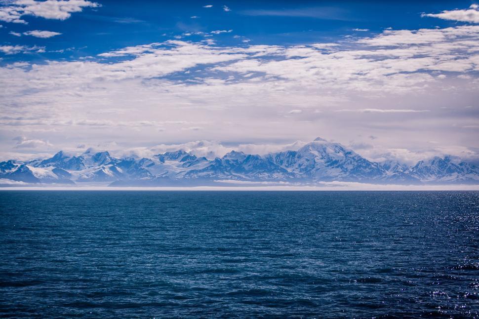 Free Image of Seascape with snowy mountain range 