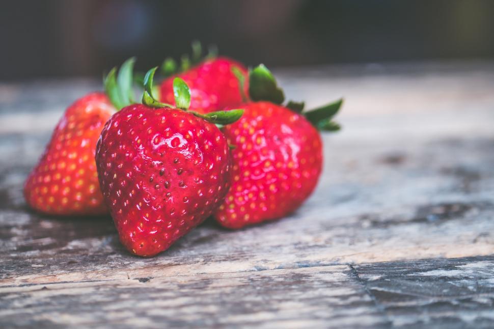 Free Image of Fresh strawberries on rustic wooden table 