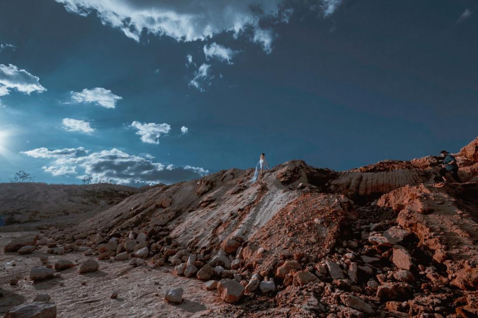 Free Image of Man on a Hill in a Rocky Landscape 