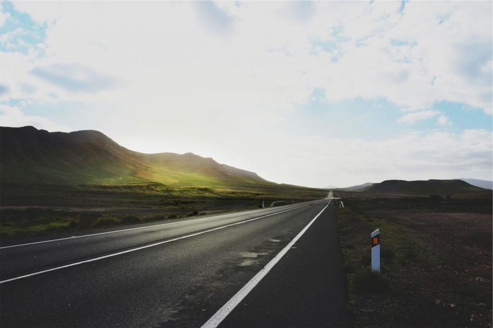Free Image of Long road stretching through a scenic landscape 