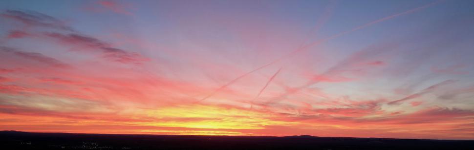 Free Image of Spectacular sunrise with vibrant hues over vast landscape 