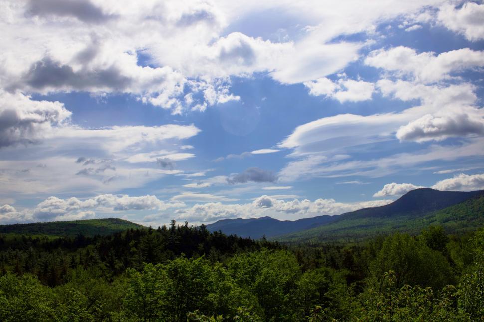 Free Image of Mountain range under a partly cloudy sky in summer. 