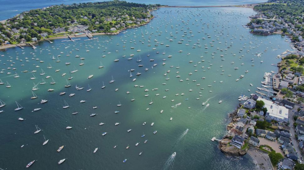 Free Image of Aerial view of a harbor with numerous anchored boats. 