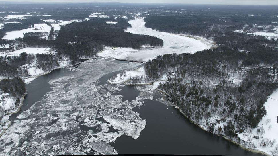 Free Image of Aerial view of a river cutting through a snowy landscape. 
