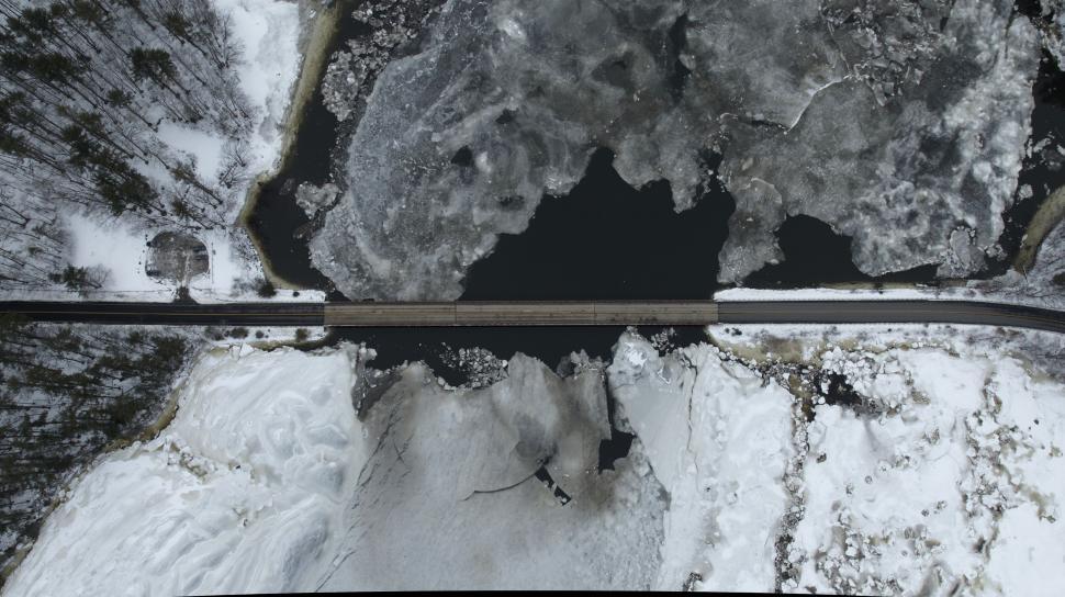 Free Image of Wintery road bridge over frozen river and landscape 
