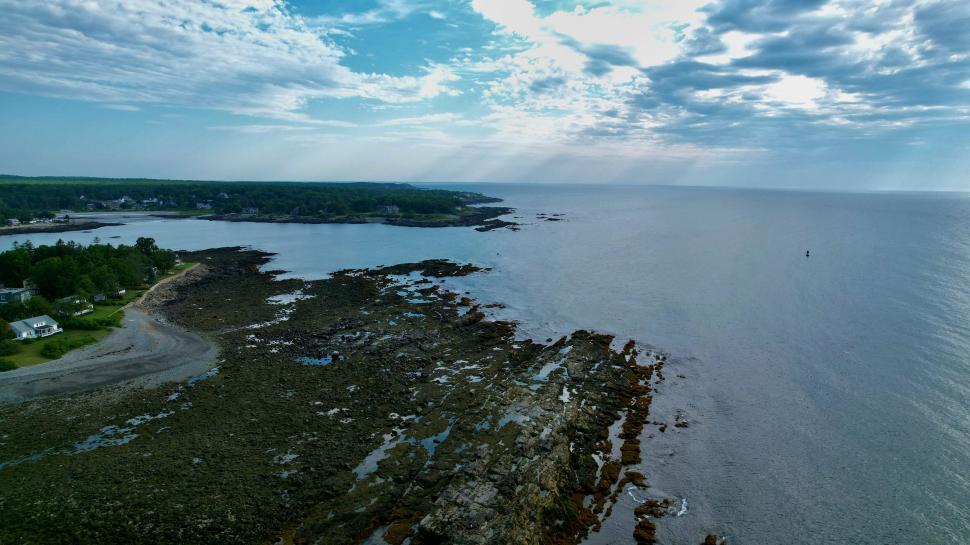 Free Image of Expansive coastline with rugged rocks and open sea 
