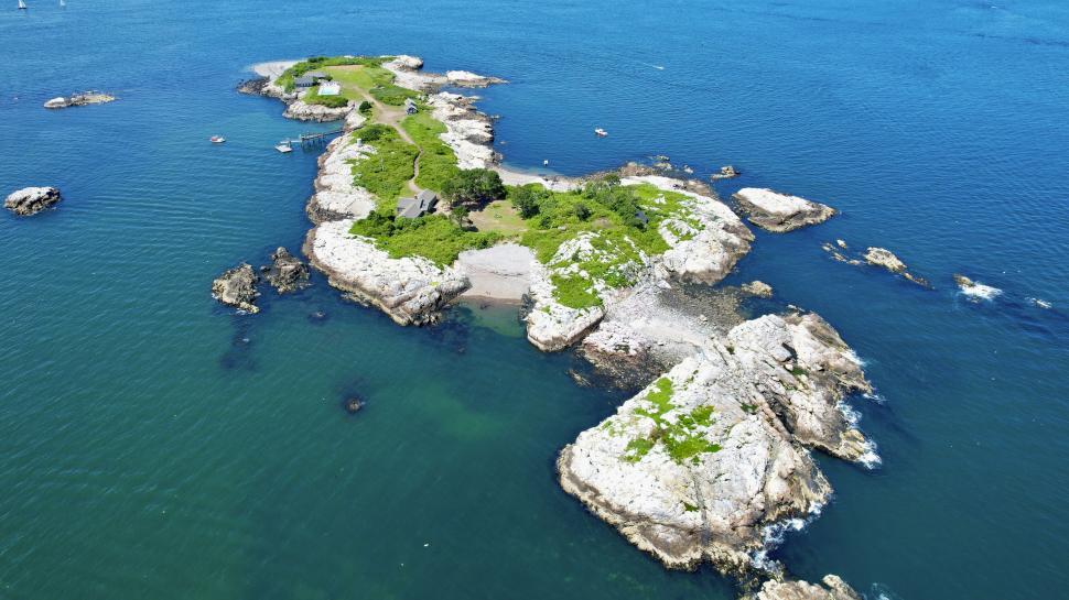 Free Image of Isolated island with rocky terrain surrounded by sea 