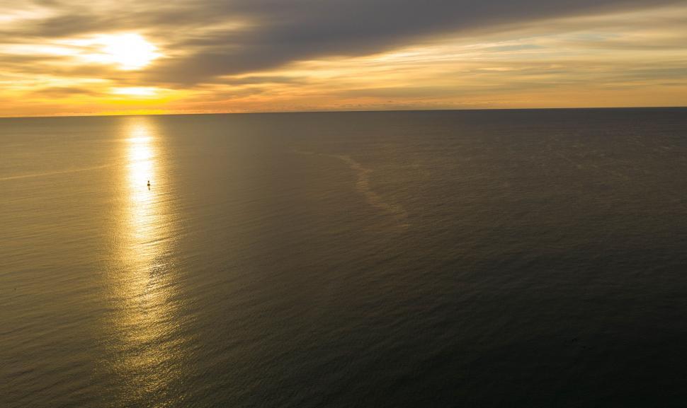 Free Image of Golden sunset over the calm, endless sea horizon 