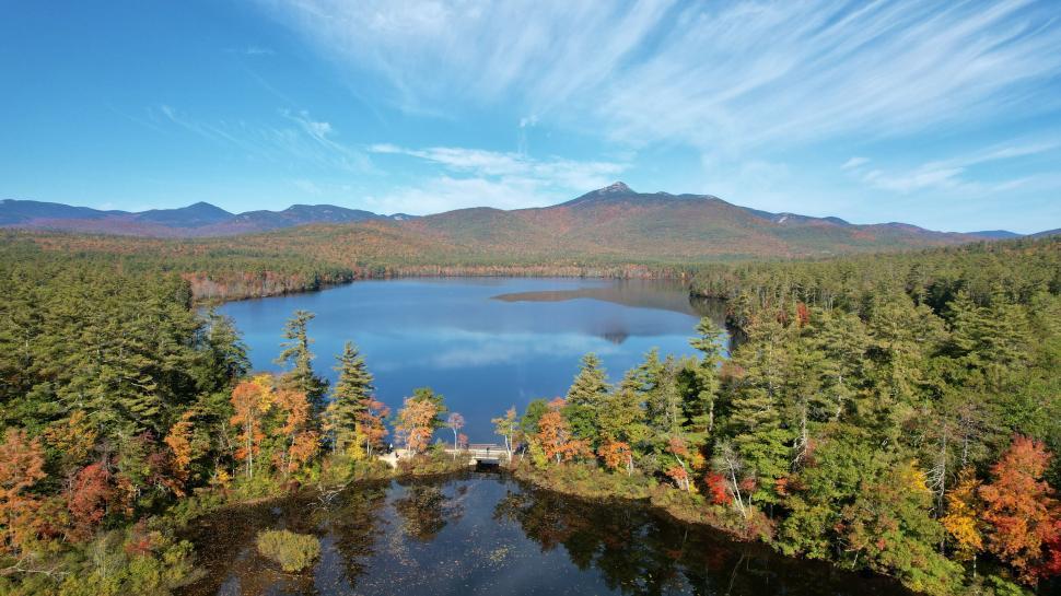 Free Image of Mountain lake in autumn surrounded by colorful trees 