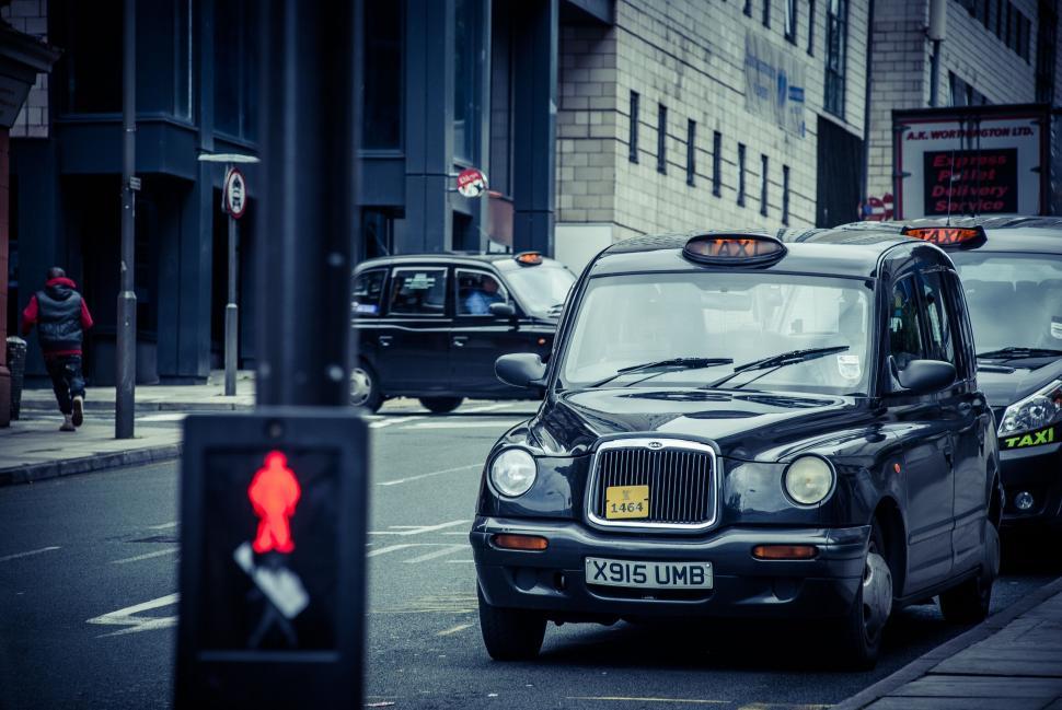 Free Image of City taxi waiting at a pedestrian crossing in traffic 
