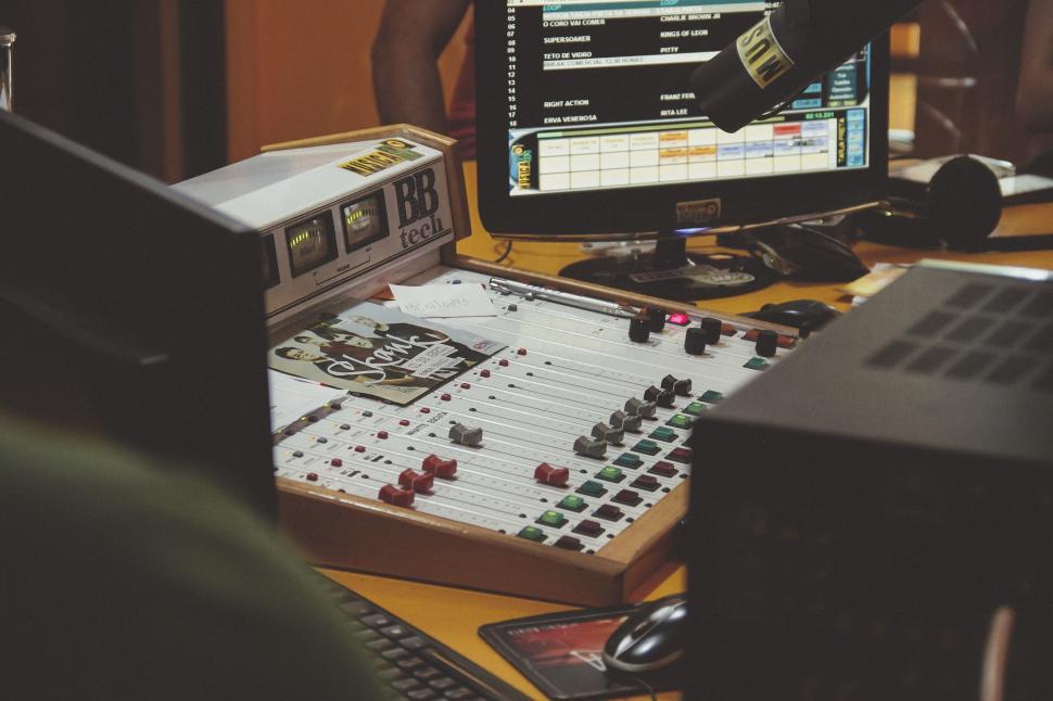 Free Image of Sound mixer board in a radio station studio workspace 