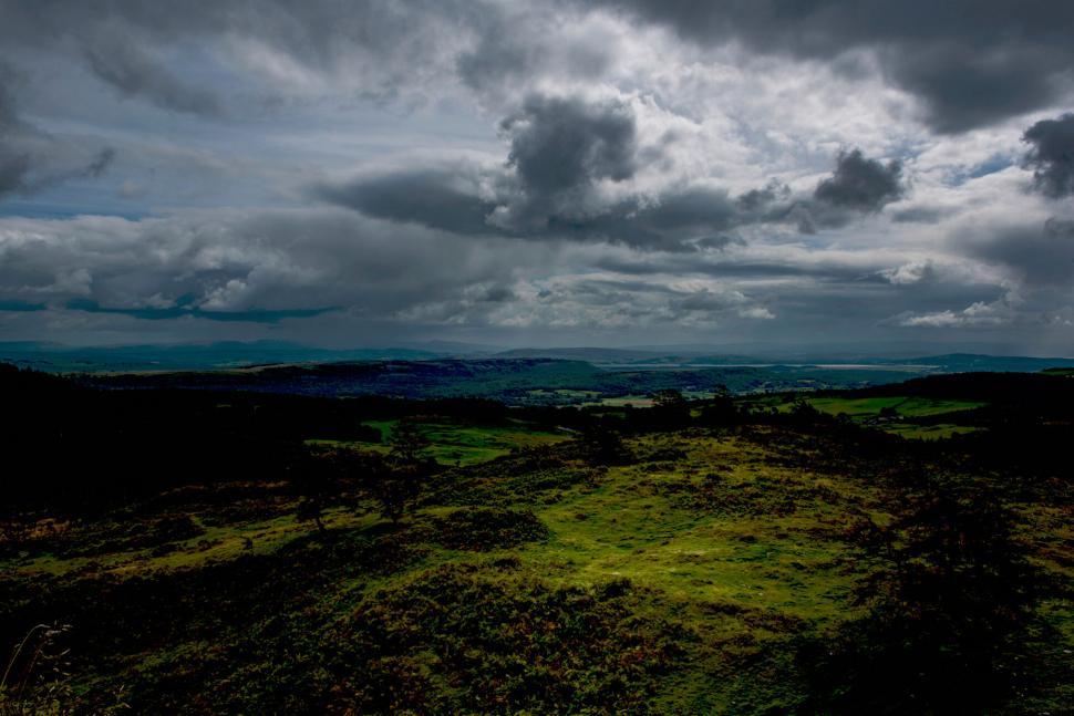 Free Image of Sweeping Landscape Under Dramatic Cloudy Skies 