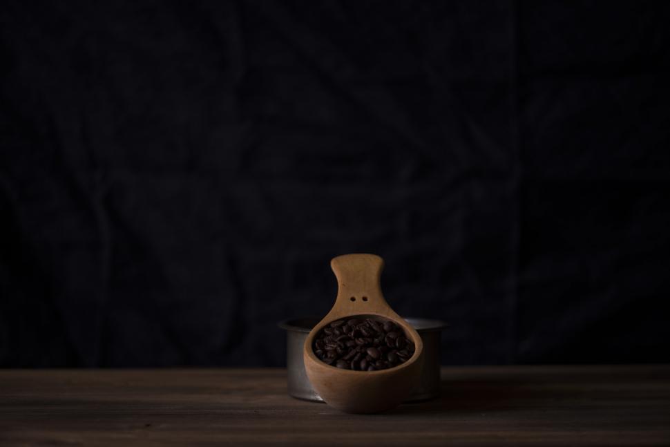 Free Image of Wooden Spoon Filled with Coffee Beans in Low Light 