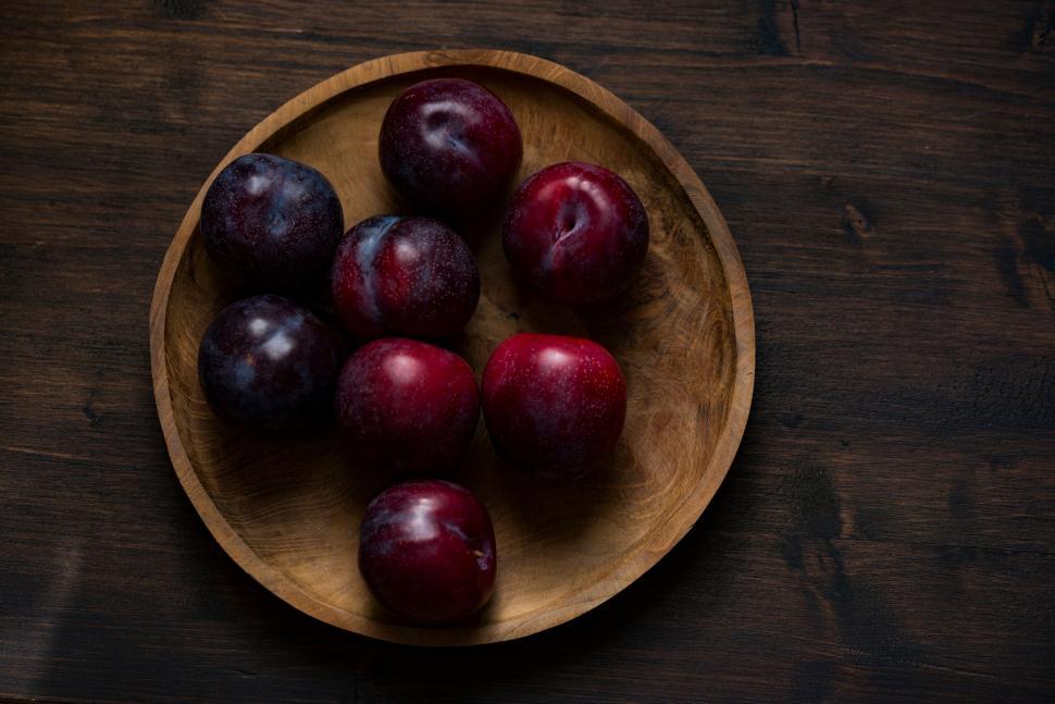 Free Image of Fresh Red and Purple Plums in a Wooden Bowl 