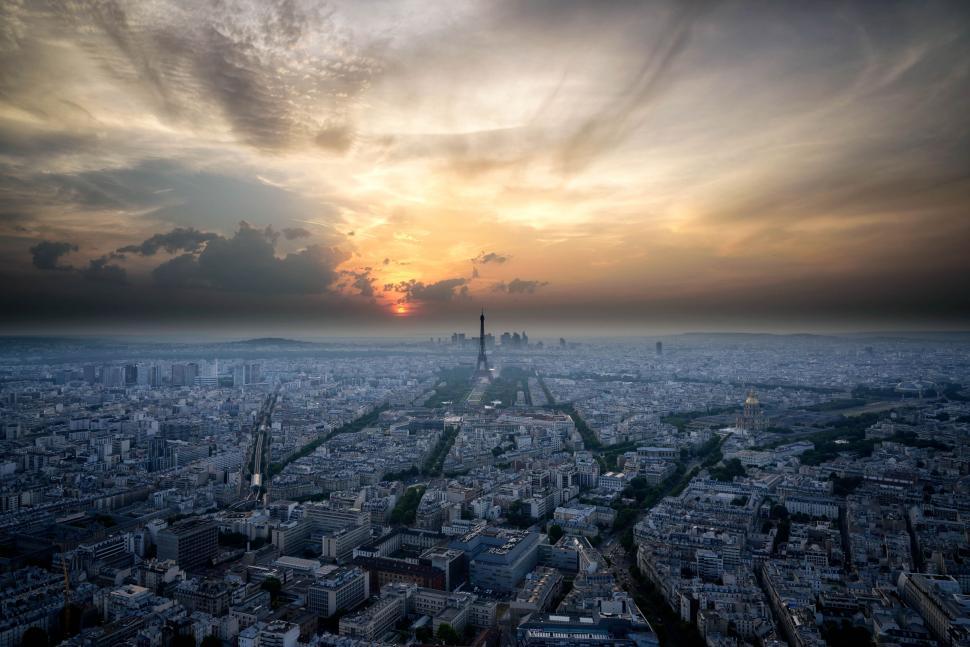 Free Image of Panoramic city view with sun setting in background sky. 