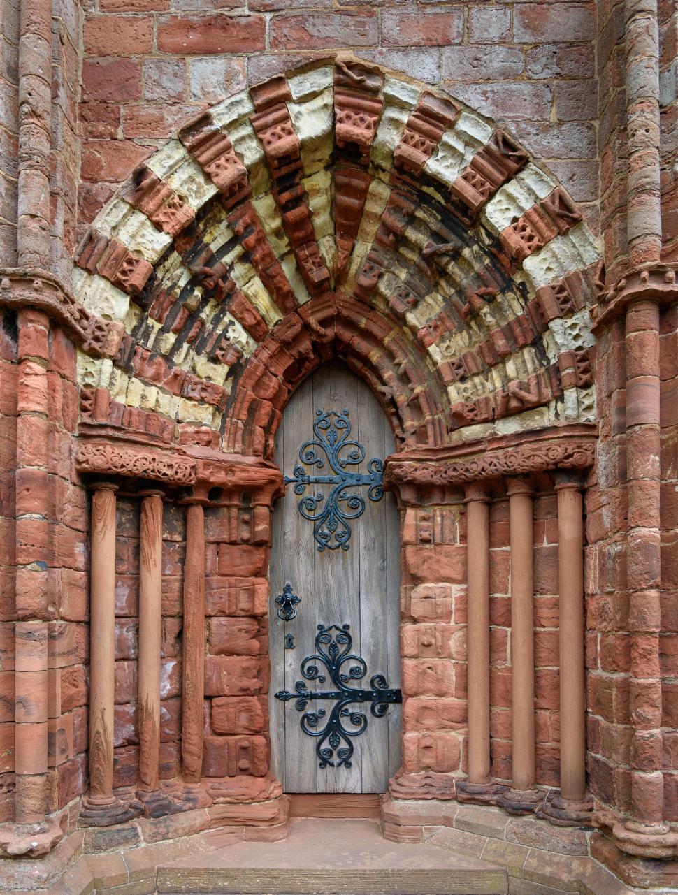 Free Image of Intricately designed medieval arched church doorway 