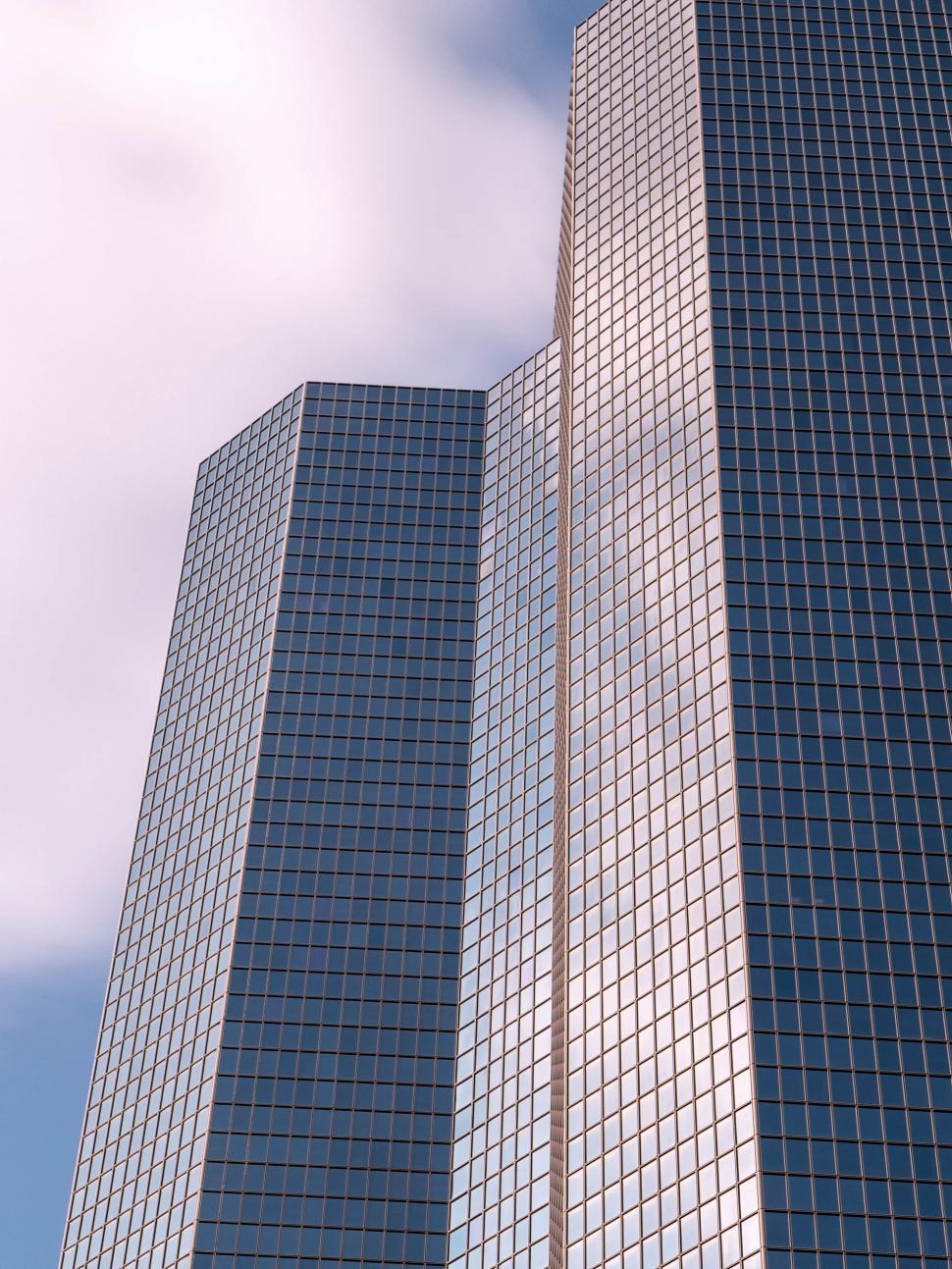 Free Image of Skyscrapers reaching towards the sky with glass facades 