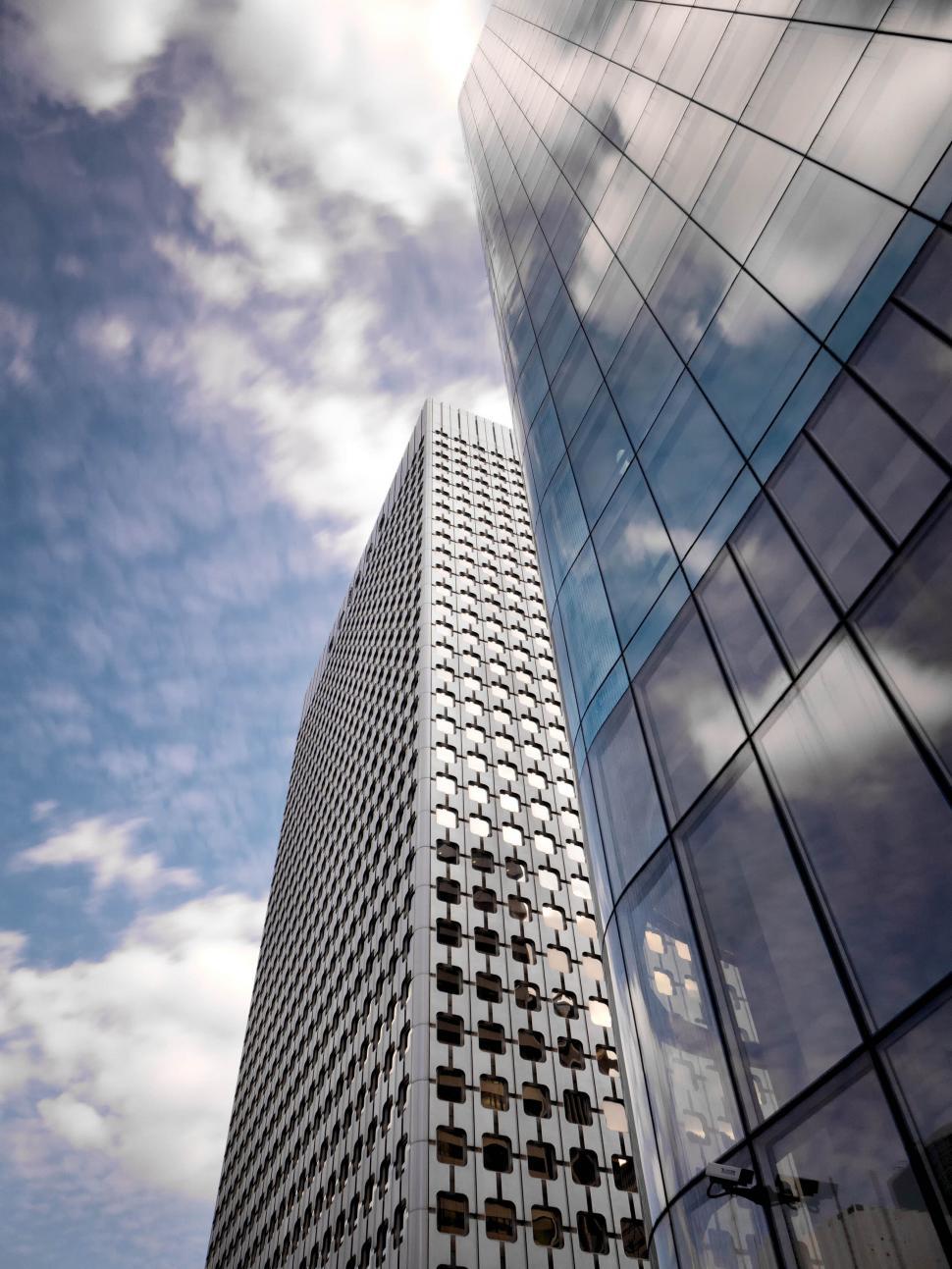 Free Image of Modern skyscrapers with reflective glass against blue sky. 