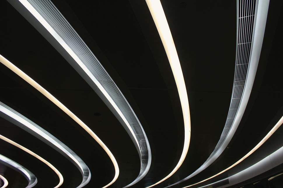 Free Image of Modern Curved Ceiling with Bright Lights in Dark Space 