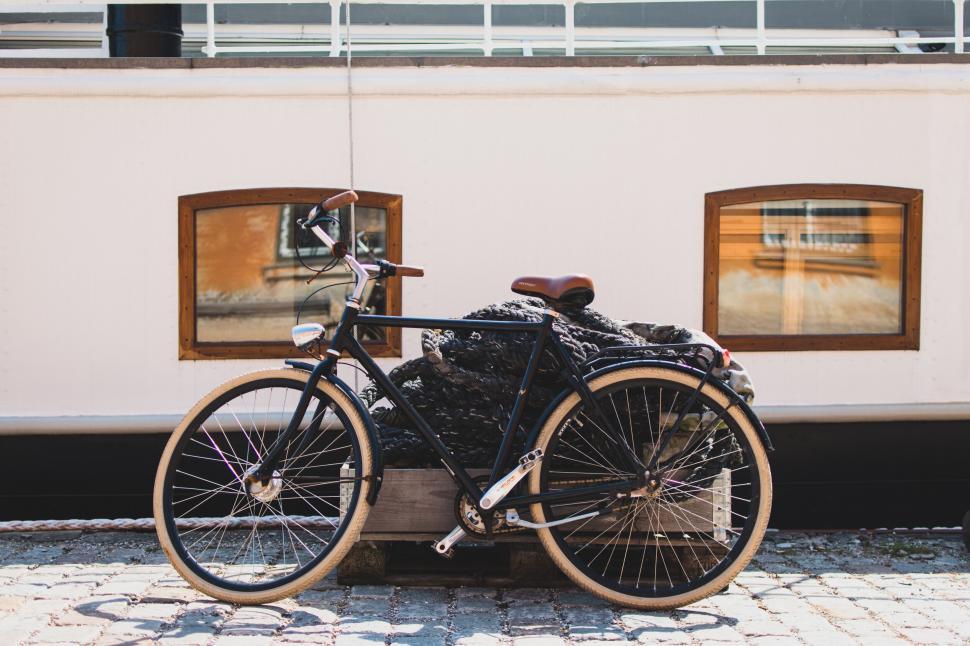 Free Image of Vintage bicycle parked in front of a white building. 