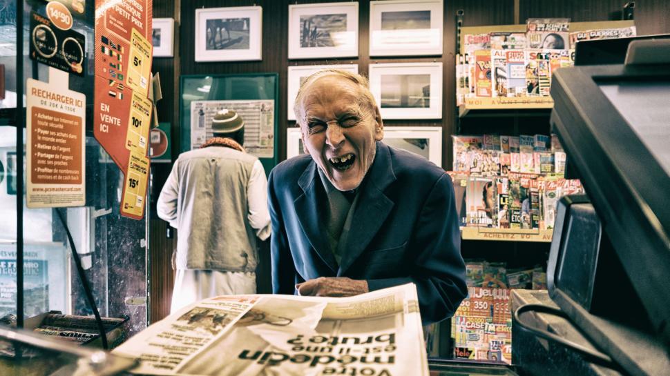 Free Image of Person at a newsstand checking out newspapers, indoor shot 