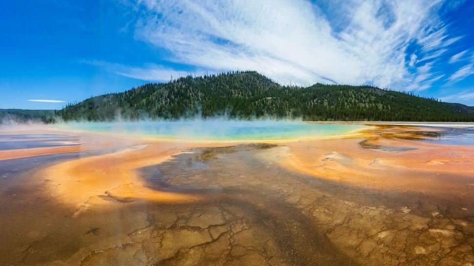Free Image of Colorful hot spring with vibrant hues and steam rising. 